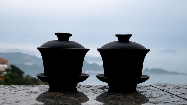 The classic Taiwanese tea cup on top of wall with sea view at Jiufen old street in Taiwan.