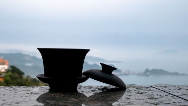 The classic Taiwanese tea cup on top of wall with sea view at Jiufen old street in Taiwan.