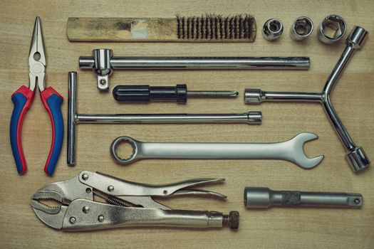 Set of many hand tools on brown wooden floor. Top view of craftsman tool on wooden table background. Top view and full frame. Concept of technician or engineer.