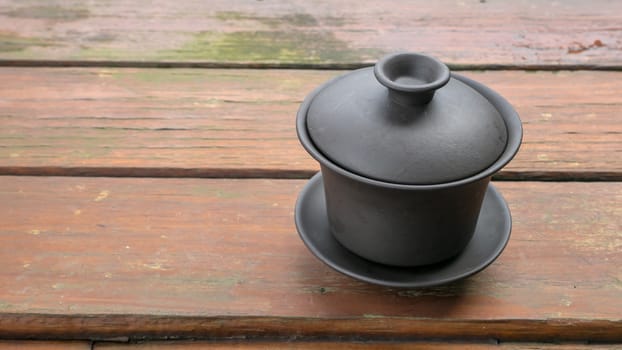 The classic Taiwanese tea cup on old wooden table.