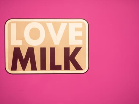 The aluminum plate in retro style pink background with copy space for decorating with love milk text.