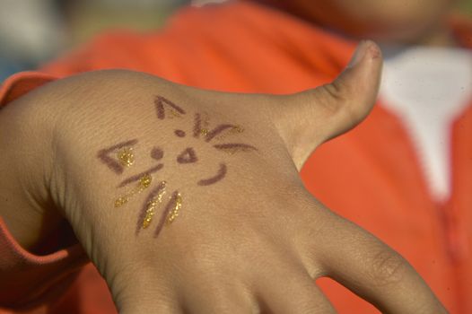 Hand of a child with drawing with joy smiling face