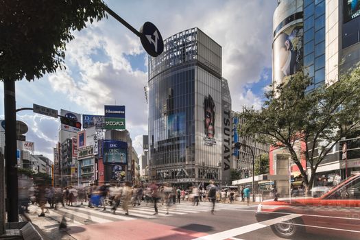 Wide view of the Shibuya Crossing Intersection in front of Shibuya Station on a bright summer day.