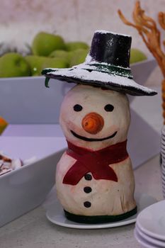 Ornamental statuette in the shape of a snowman in a buffet