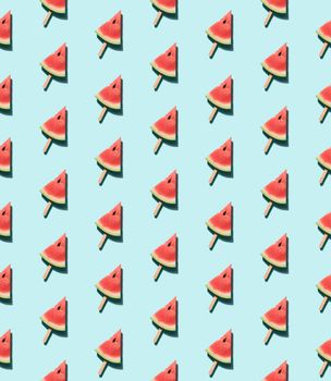 watermelon popsicle seamless pattern. Water melon slice on wooden popsicle stick over blue background. Top view or flat lay. Isometric view