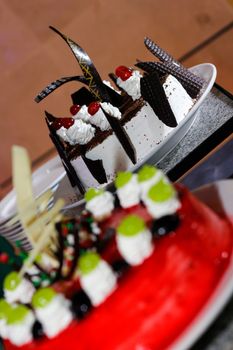 Tray full of cupcakes and slices of cake inside a buffet