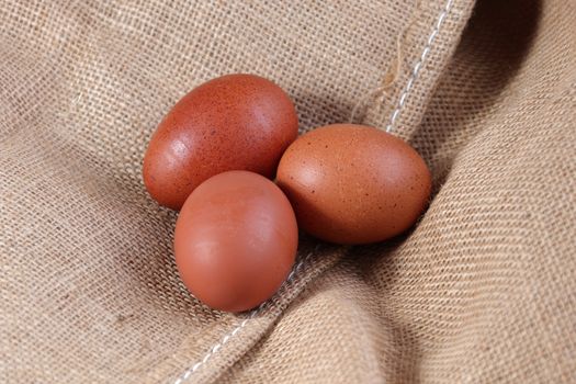 Chicken eggs on a burlap hessian sack