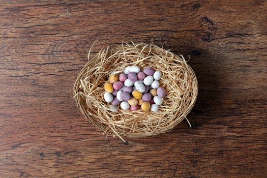 Group of Easter eggs in a basket with old wooden background