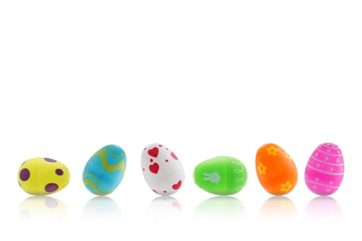 A set of Easter toy eggs on white with reflection