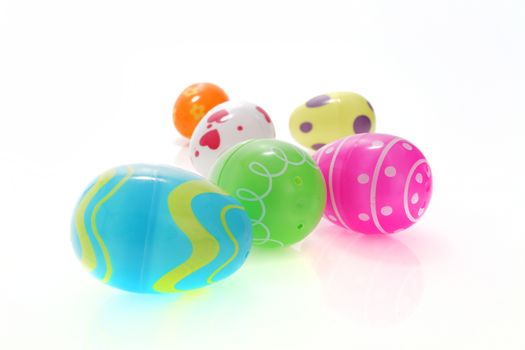 A set of colorful Easter egg toys on white with selective focus and shallow depth of field
