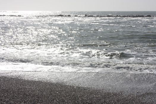 A winter beach with rough seas with cold and dull colors in the Versilian Riviera in italy