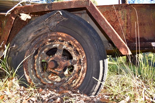 The tyre on an old, rusted trailer