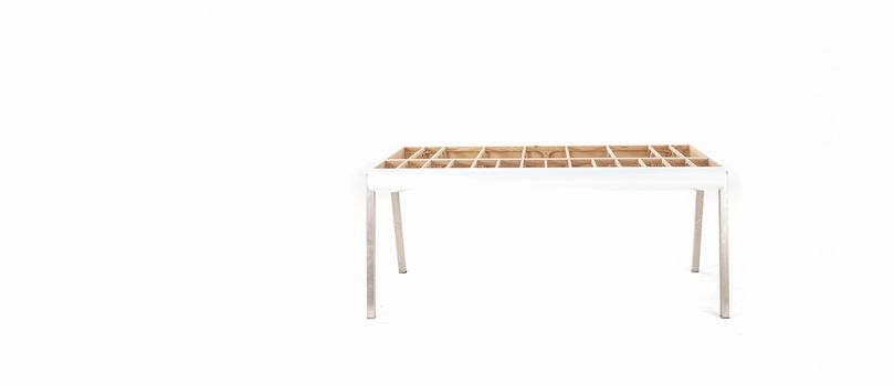 hand made designer table showing framework without table top with white copy space