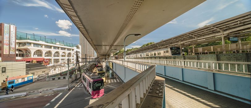 Oji station JR Keihin Tohoku Line in the Kita district, north of Tokyo. The pedestrian walkway spans the intersection of Meiji Avenue where the Ojiekimae station of the Toden Arakawa tram line is famous for its retro style.