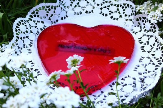 The picture shows a red heart dessert for mother`s day