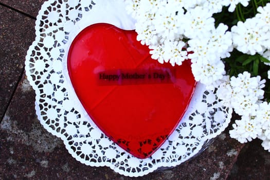 The picture shows a red heart dessert for mother`s day