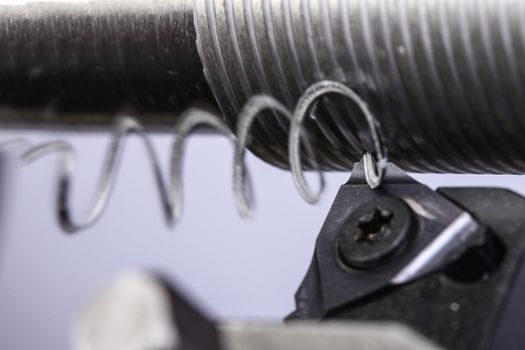 close up of metal cutting on lathe with metal carving off
