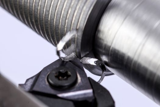 close up of metal cutting on lathe with metal carving off