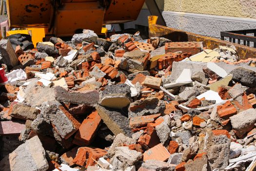 disposed red bricks piled up on junkyard. Brick rubble