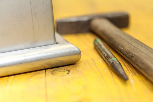hammer and chisel tools for plumbers. With yellow background