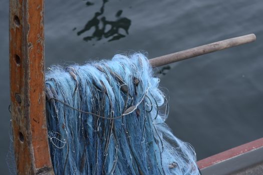 fish net in fishing boat on lake zug. With blue strings
