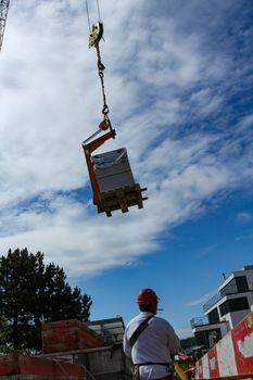 Hard working people at construction site. with blue sky