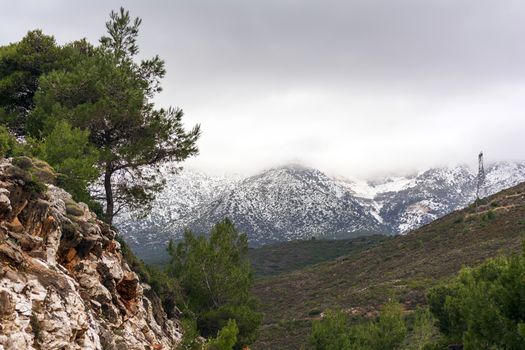 Penteli mountain with peak covered in snow. Attica. Greece.