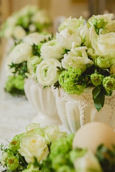 Wedding table decoration, wedding setting, wedding flowers on table, shallow depth of field.