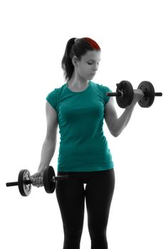 Fit attractive young woman doing dumbbell concentration curls, backlit silhouette studio shot isolated on white background. Fitness and healthy lifestyle concept. Young woman exercising with dumbbells.