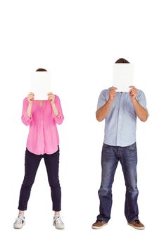 People holding sheets over faces on white background