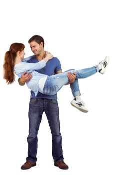 Man lifting up his girlfriend on white background