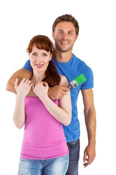 Couple hugging and holding brush on white background