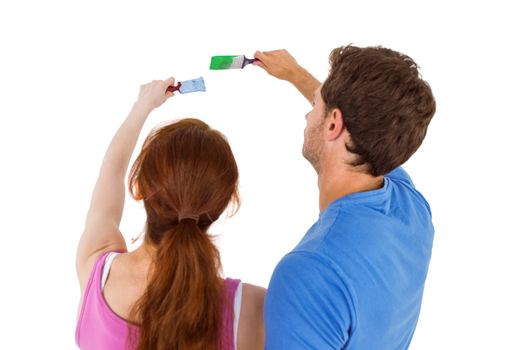 Couple both about to paint on white background