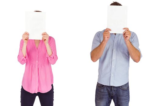 People holding sheets over faces on white background
