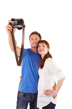 Couple using camera for picture on white background