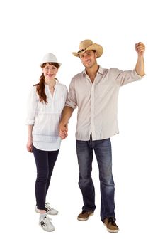 Smiling couple both wearing hats on white background
