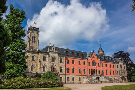 Sychrov Castle with typical pink facade. Neo-Gothic style chateau with beautiful english style park. Bohemian Paradise, Czech Republic
