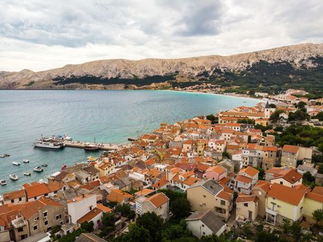 Aerial panoramic view of Baska town, popular touristic destination on island Krk, Croatia, Europe.