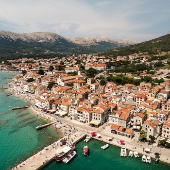 Aerial panoramic view of Baska town, popular touristic destination on island Krk, Croatia, Europe.