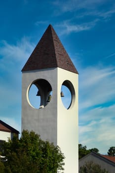 A church's bell tower against a clear blue sky