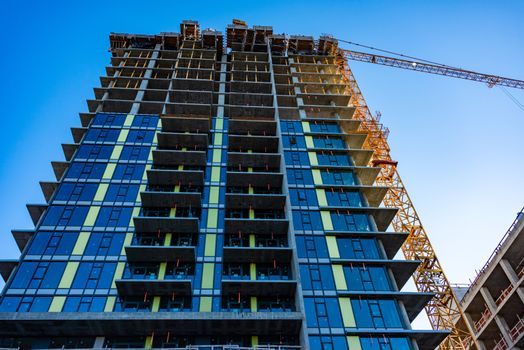 Monolite concrete building under constraction on blue sky background