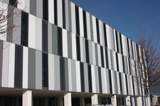 Public hospital healthcare facility in Italy in a building in northern Tuscany made of gray white and black vertical rectangular textures in Massa