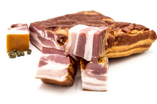 Piece of smoked bacon with meat and cubed cut on an isolated white background.