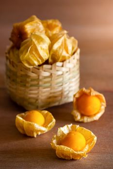 Cape gooseberry in bamboo basket. Concept of health care or herb. Closeup and copy space for text.