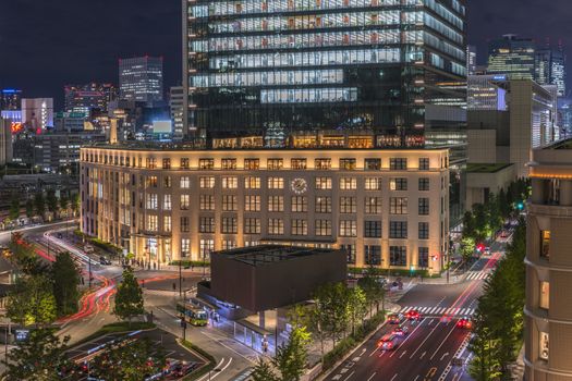 Night view of KITTE commercial facility building deployed by Japan Post in 2013, The GranTokyo and Pacific Century Place Marunouchi skyscrapers overlooking the railroad tracks of Tokyo Station. The GranTokyo building, whose first 14 storeys are occupied by the Daimaru department store, is 205 meters high and was inaugurated in 2007. The Pacific Century Place building is 150 meters and 32 storeys high and was inaugurated in 2001.
