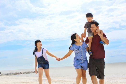 happy asian family having fun on beach.