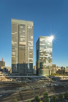 The GranTokyo and Pacific Century Place Marunouchi skyscrapers overlooking the railroad tracks of Tokyo Station. The GranTokyo building, whose first 14 storeys are occupied by the Daimaru department store, is 205 meters high and was inaugurated in 2007. The Pacific Century Place building is 150 meters and 32 storeys high and was inaugurated in 2001.