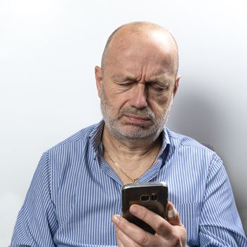 A middle-aged man bored while talking on a cell phone