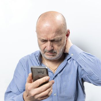 A middle-aged man worried while talking on a cell phone