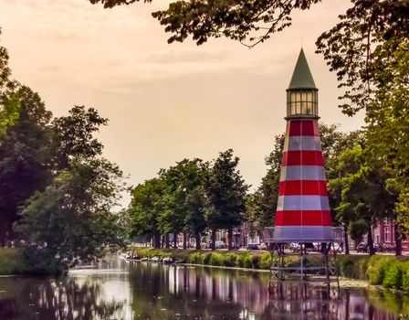 Canal with lighthouse in valkenberg park Breda, Beautiful urban scenery of the Netherlands